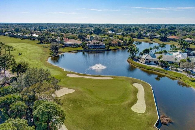 aerial overview of property's location with a golf course, a nearby body of water, a tree filled landscape, and nearby suburban area