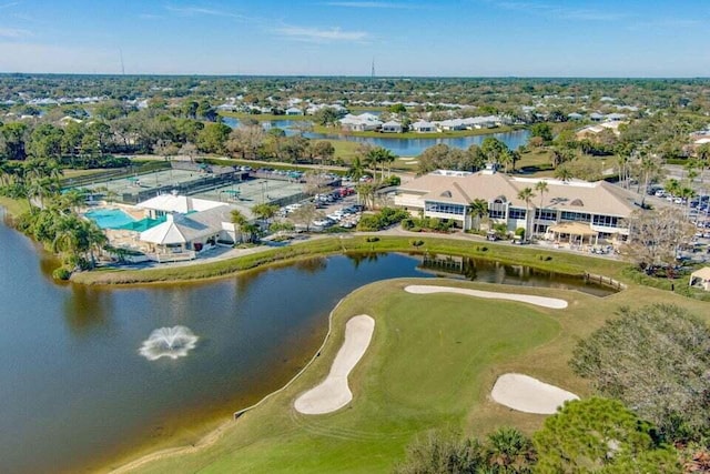 view of property location with a golf course and a large body of water