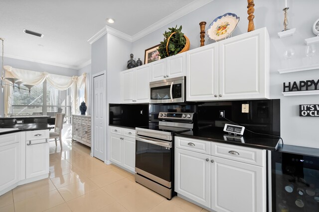 kitchen with stainless steel dishwasher, a sink, a peninsula, crown molding, and light tile patterned flooring
