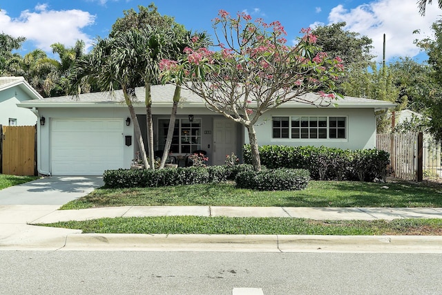 ranch-style home featuring concrete driveway, a porch, fence, and a garage