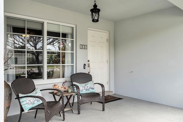 property entrance with a porch and stucco siding