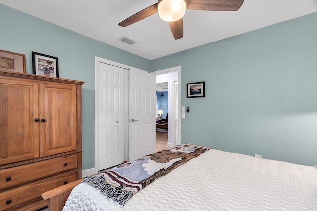 bedroom with ceiling fan, baseboards, a closet, and visible vents