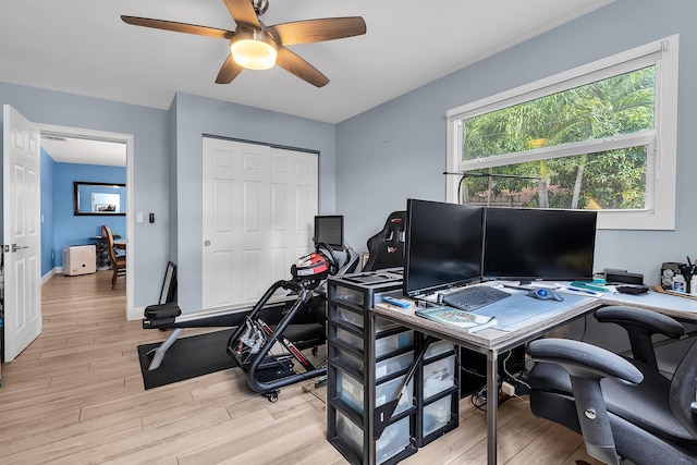 home office with light wood finished floors, baseboards, and ceiling fan