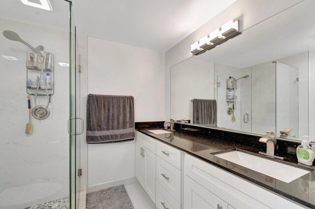 full bath with a stall shower and double vanity