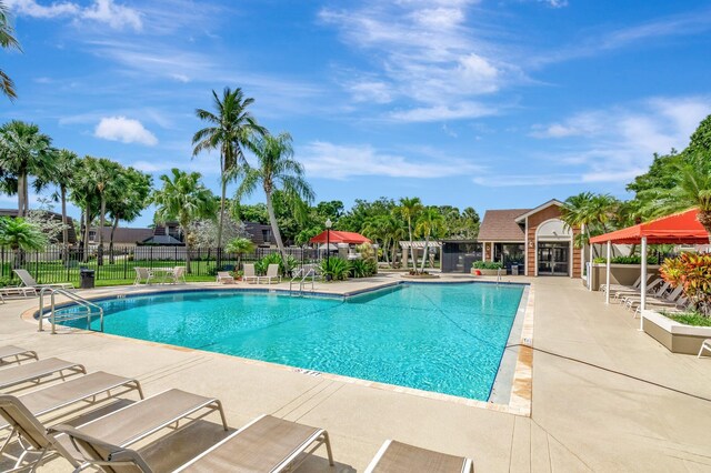 community pool featuring a patio and fence