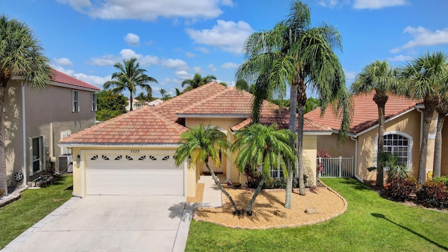 7523 Oakboro Dr, Lake Worth, FL 33467 - view of front facade with stucco siding, a tiled roof, a garage, driveway, and central air condition unit
