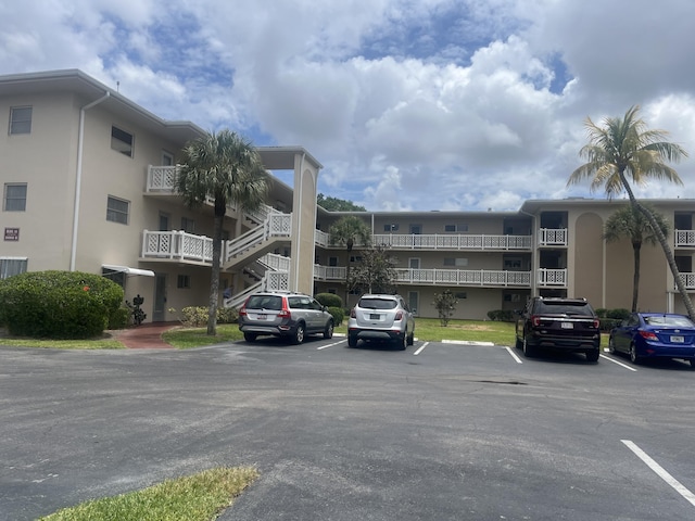view of building exterior with uncovered parking