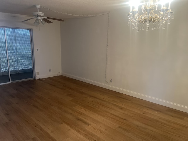 unfurnished room with baseboards, ceiling fan with notable chandelier, and wood finished floors