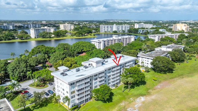 drone / aerial view featuring a view of city and a water view