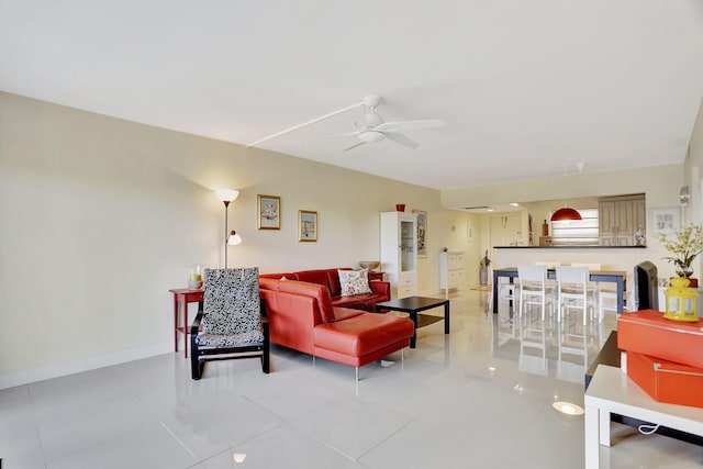 living room featuring ceiling fan and light tile patterned flooring