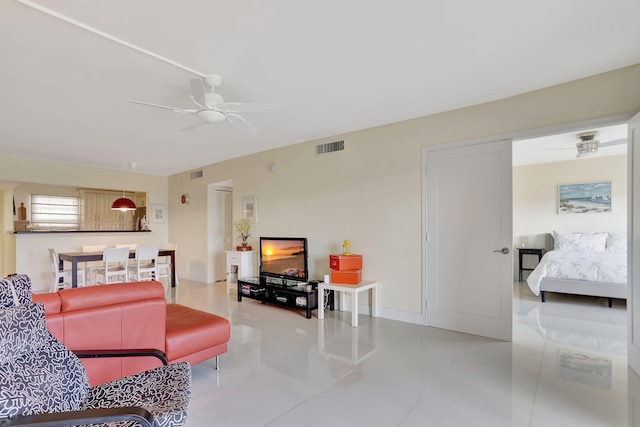 living area featuring ceiling fan, light tile patterned flooring, and visible vents