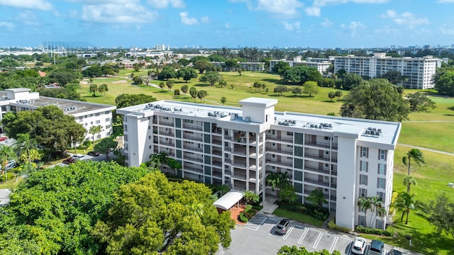 birds eye view of property featuring a city view and golf course view
