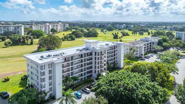 bird's eye view featuring view of golf course and a city view