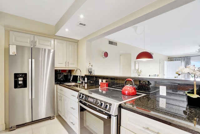 kitchen with visible vents, a sink, stainless steel refrigerator with ice dispenser, dark stone counters, and electric stove