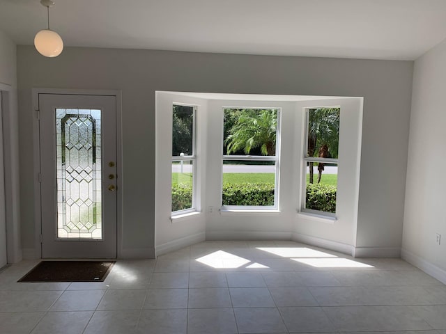 tiled foyer entrance with baseboards