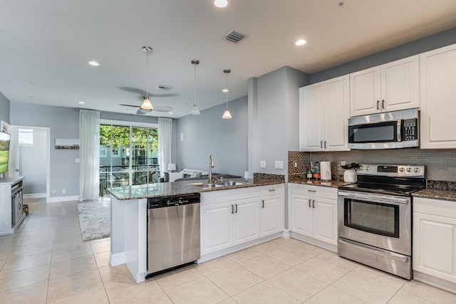 75 Atlantic Grove Way, Delray Beach, FL 33444 - kitchen with appliances with stainless steel finishes, a sink, tasteful backsplash, a peninsula, and light tile patterned floors