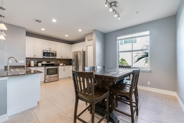 75 Atlantic Grove Way, Delray Beach, FL 33444 - kitchen featuring appliances with stainless steel finishes, a sink, light tile patterned floors, dark stone countertops, and recessed lighting