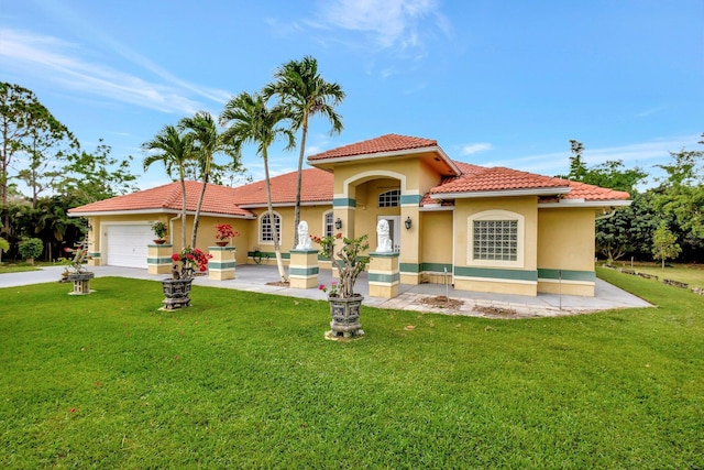 mediterranean / spanish-style home featuring a tile roof, an attached garage, stucco siding, and a front lawn