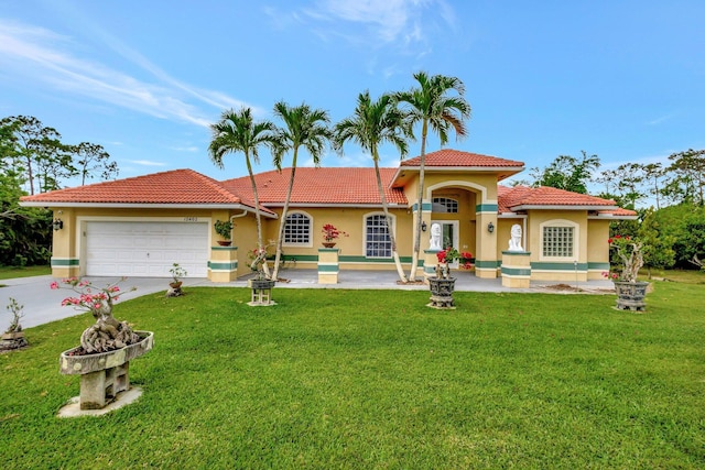 mediterranean / spanish home featuring a garage, a tiled roof, stucco siding, a front lawn, and driveway