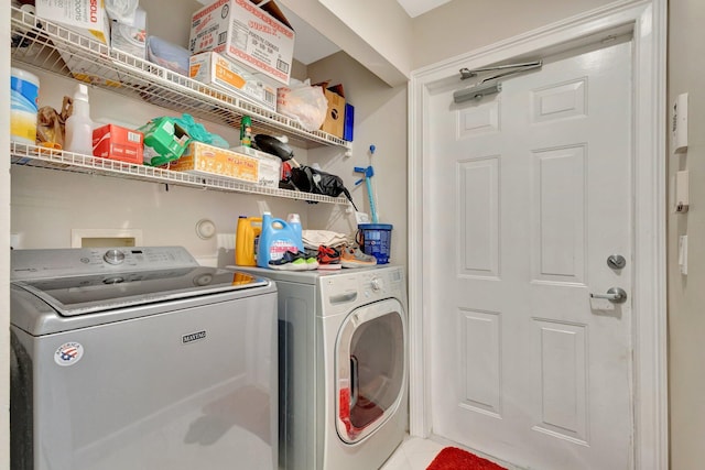 clothes washing area featuring washing machine and dryer and laundry area