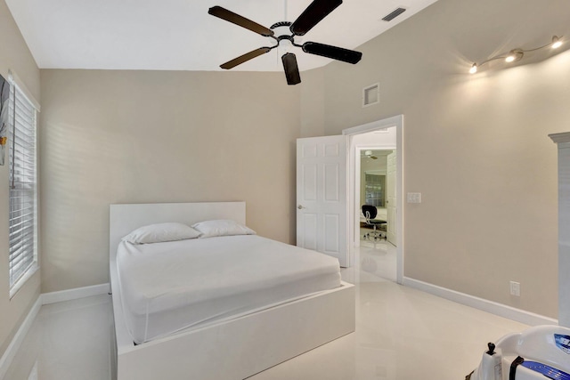 bedroom with a ceiling fan, visible vents, and vaulted ceiling