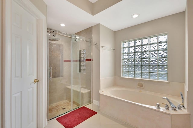 full bathroom featuring tile patterned floors, a bath, a stall shower, and recessed lighting