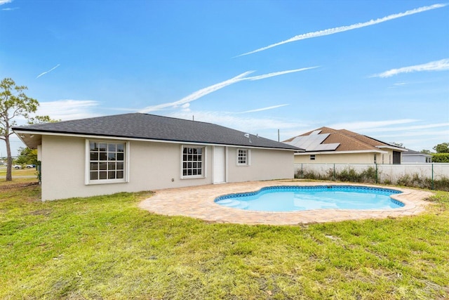 view of pool with fence, a fenced in pool, a lawn, and a patio