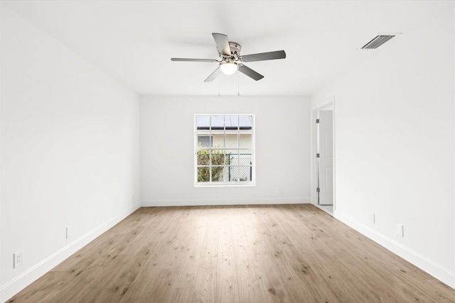 unfurnished room with visible vents, baseboards, and ceiling fan