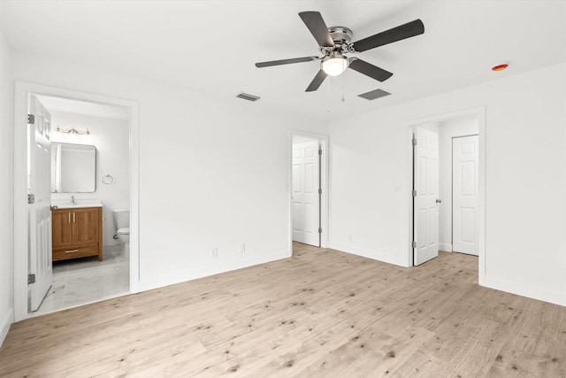unfurnished bedroom with visible vents, baseboards, and wood finished floors