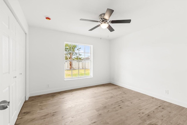 unfurnished bedroom featuring baseboards, a closet, and wood finished floors