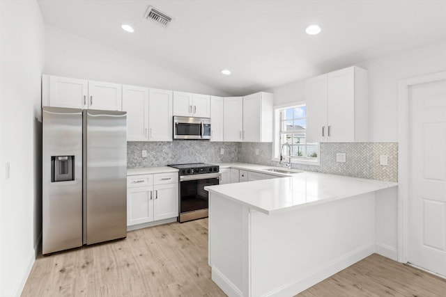 kitchen with light countertops, appliances with stainless steel finishes, light wood finished floors, and visible vents
