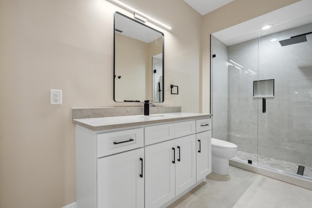 bathroom featuring vanity, toilet, and a stall shower