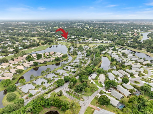 birds eye view of property featuring a water view and a residential view