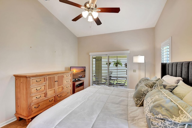 bedroom with multiple windows, high vaulted ceiling, wood finished floors, ceiling fan, and baseboards