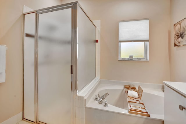 bathroom with a shower stall and a garden tub