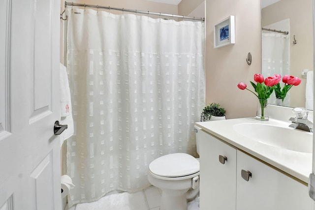 bathroom featuring tile patterned flooring, toilet, and vanity