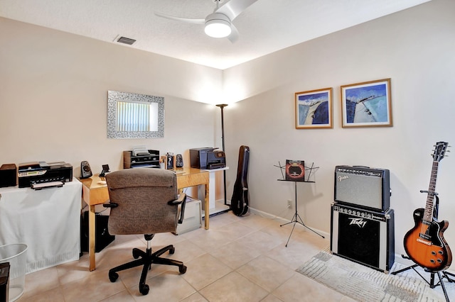 office space featuring ceiling fan, light tile patterned floors, and baseboards