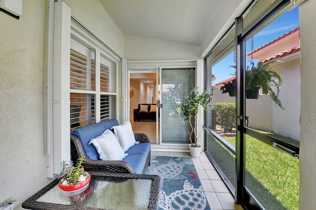 sunroom featuring vaulted ceiling