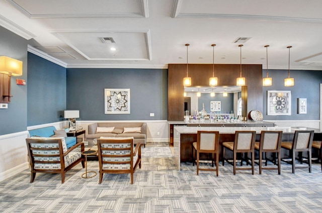 bar featuring coffered ceiling, light colored carpet, ornamental molding, pendant lighting, and beam ceiling