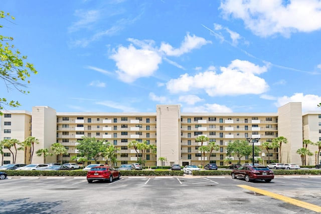 view of building exterior featuring uncovered parking