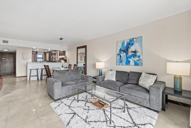 living room featuring visible vents and baseboards