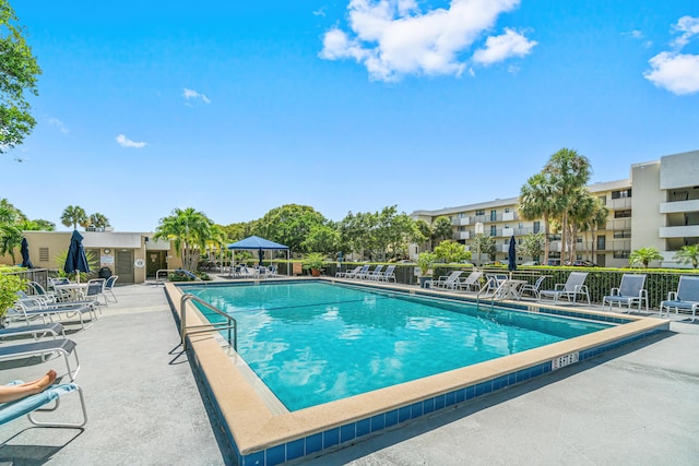 pool featuring fence and a patio