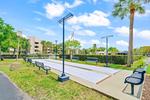 view of property's community featuring shuffleboard, a residential view, and a lawn