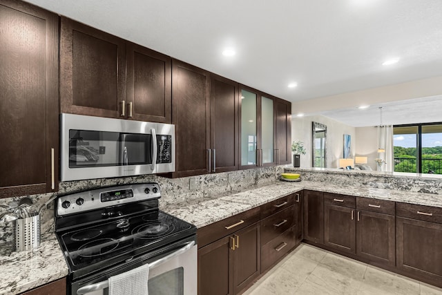 kitchen featuring light stone countertops, recessed lighting, glass insert cabinets, dark brown cabinetry, and stainless steel appliances