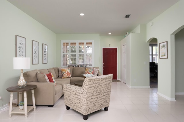 520 NW Galatone Ct, Port Saint Lucie, FL 34986 - living room featuring light tile patterned floors, arched walkways, baseboards, and recessed lighting