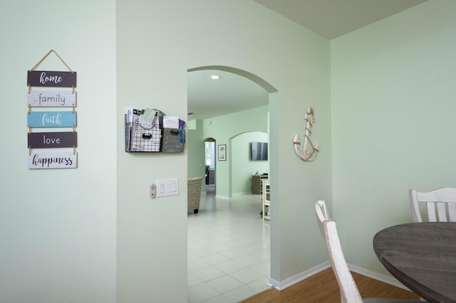 520 NW Galatone Ct, Port Saint Lucie, FL 34986 - hall with baseboards, arched walkways, and tile patterned flooring