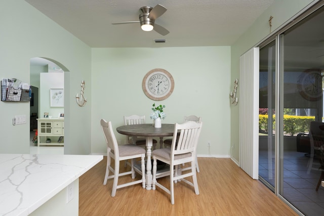 520 NW Galatone Ct, Port Saint Lucie, FL 34986 - dining area with visible vents, arched walkways, light wood-style flooring, and ceiling fan