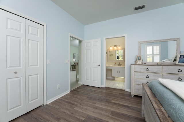 520 NW Galatone Ct, Port Saint Lucie, FL 34986 - bedroom featuring baseboards, a closet, dark wood-style floors, and visible vents