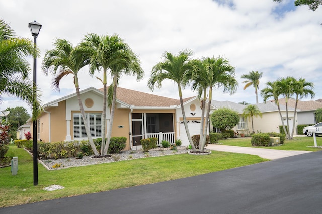 520 NW Galatone Ct, Port Saint Lucie, FL 34986 - ranch-style home featuring stucco siding, concrete driveway, a front lawn, and a garage