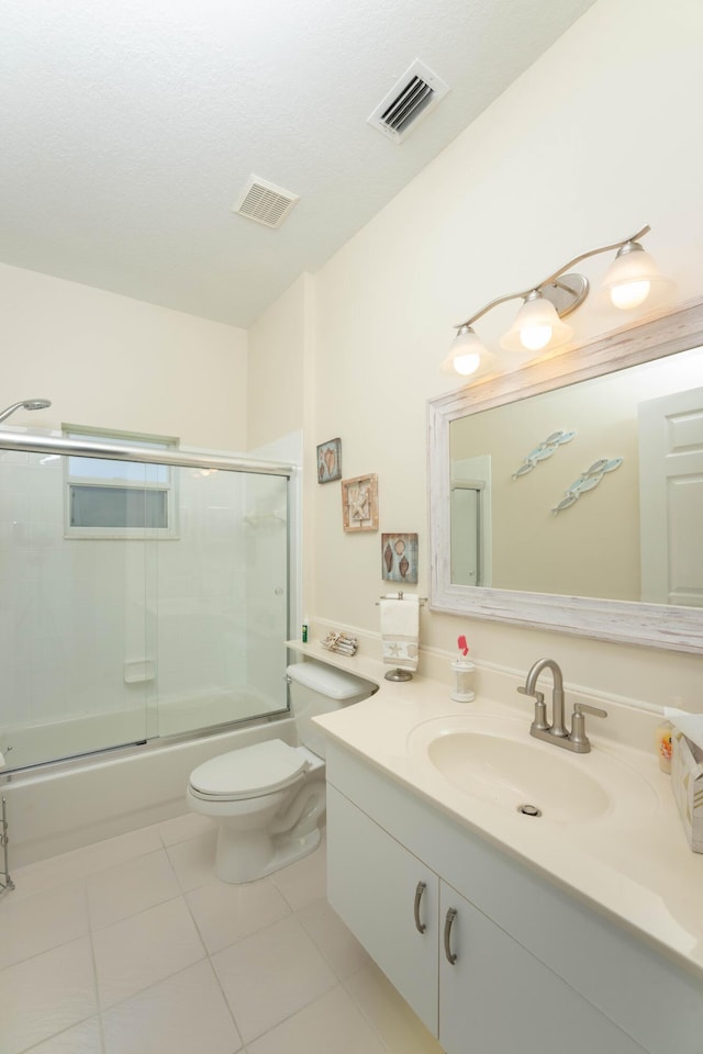 520 NW Galatone Ct, Port Saint Lucie, FL 34986 - bathroom with tile patterned flooring, combined bath / shower with glass door, toilet, and visible vents